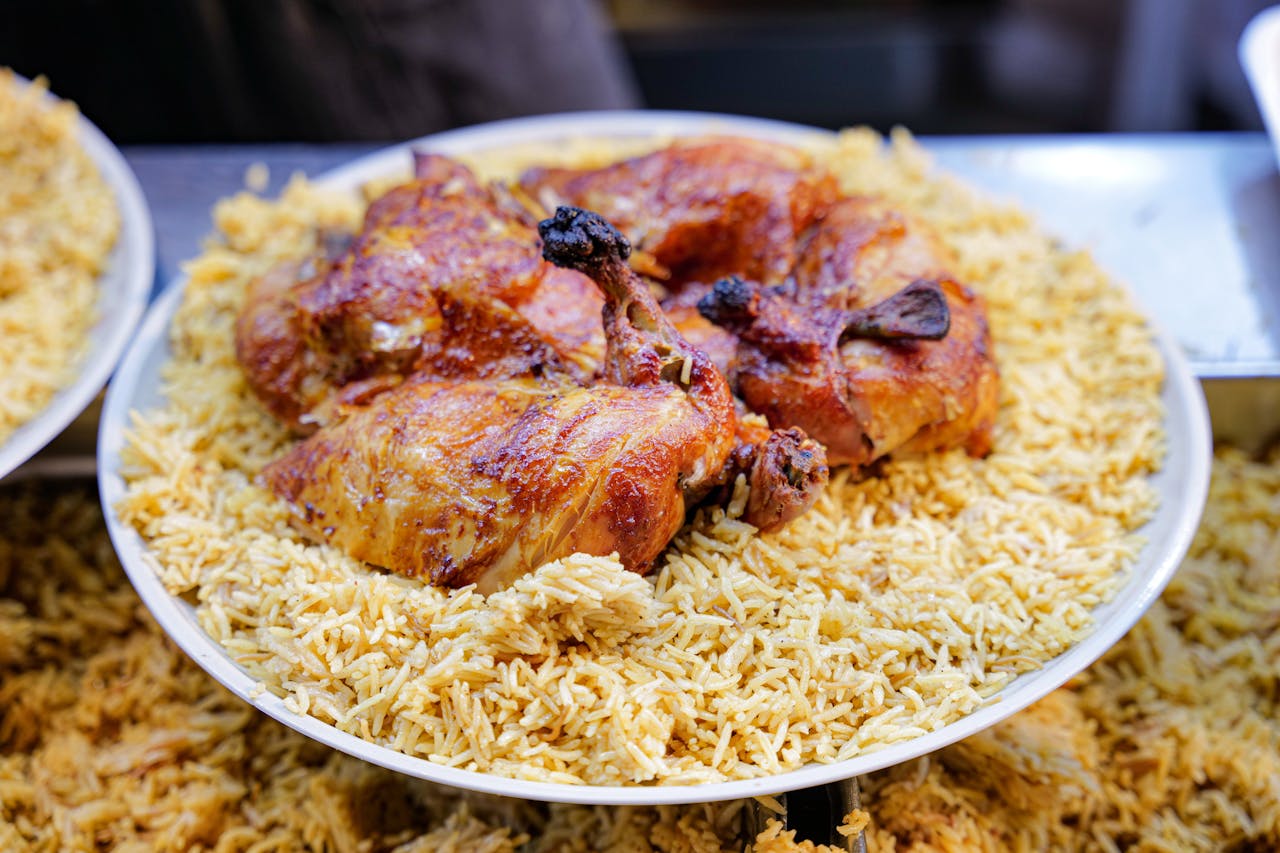 Close-up of a delicious chicken and rice meal served on a plate, perfect for food lovers.